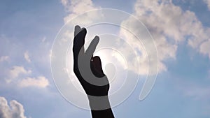 Close up of man hands playing  hand with the sun light on the blue sky background