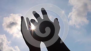 Close up of man hands playing  hand with the sun light on the blue sky background