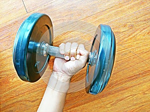 Close up of man holding barbell in gym