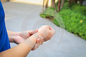 Close up man holding her wrist symptomatic Office Syndrome.