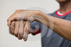 Close-up of a man holding his hand due to nerve endings