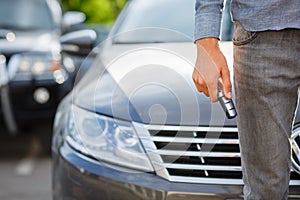 Close-up of man holding keys to new car. Copy space.