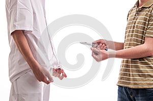 Close up of man, holding a knife in his hands, threatening a doctor