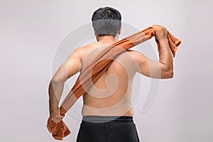 Close up man holding towel to rub the body dry after shower. To used wet towel can be the dermatitis on the body concept