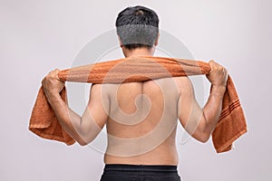 Close up man holding towel to rub the body dry after shower. To used wet towel can be the dermatitis on the body concept