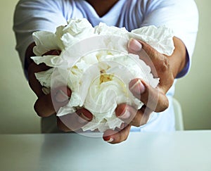 Close up a man holding white tissue for using for cleaning in the room.