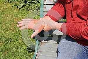 Close up man holding wrist. painful arthritis.