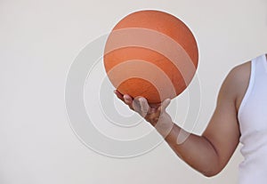 Close up man holds orange basketball. Concept, sport equipment.