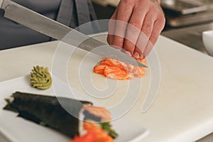 Close up of man japanese restaurant chef cooking sushi in the kitchen