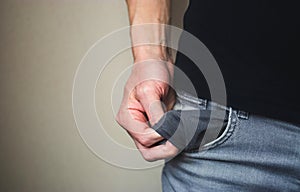 Close up man in jeans and shows an empty pocket with no money