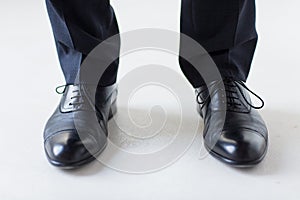 Close up of man legs in elegant shoes with laces