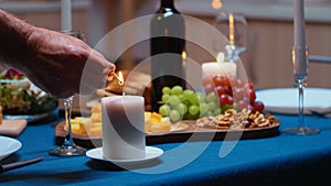 Close up of man lighting the candle