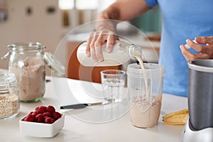 Close Up Of Man Making Protein Shake After Exercise At Home photo