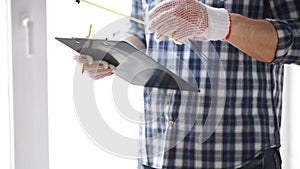 Close up of man with measuring ruler and clipboard