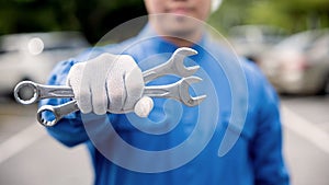 Close up of Man mechanic holding wrench.