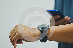 Close up Man with Mobile phone connected to a smart watch