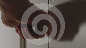 CLOSE UP: Man opens a door in the room using the door handle in the house