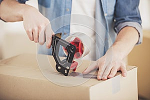 Close-up. Man packing boxes. Moving, purchase of new habitation