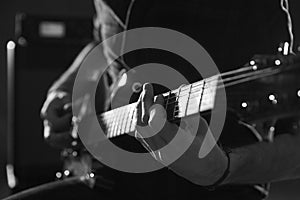 Close Up Of Man Playing Electric Guitar Shot In Monochrome