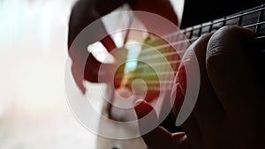 Close up man playing guitar, his right hand play scale chord and left hand play string