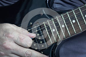 Close-up of man playing lead guitar solo