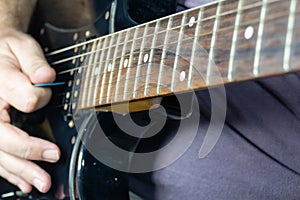 Close-up of man playing lead guitar solo