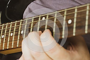 Close-up of man playing lead guitar solo