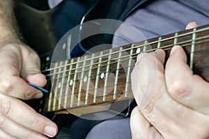 Close-up of man playing lead guitar solo