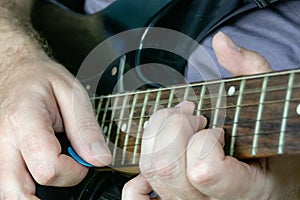 Close-up of man playing lead guitar solo