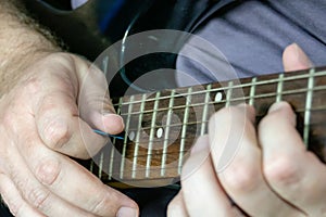 Close-up of man playing lead guitar solo