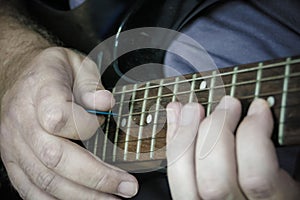 Close-up of man playing lead guitar solo