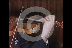 Close-up of a man playing violin