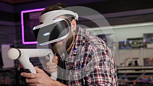 A close-up of a man playing a VR game in an entertainment center.