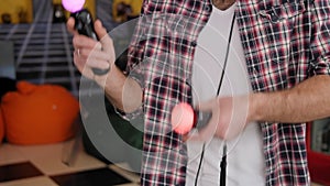 A close-up of a man playing a VR game in an entertainment center.