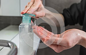 Close up. man pressing the dispenser with bactericidal soap.