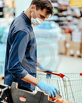 close up. man in a protective mask choosing products in a supermarket.