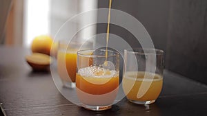 Close up of man pur orange juice in glass