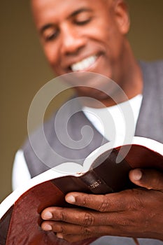 Close up of a man reading the Bible.