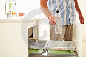 Close Up Of Man Recycling Kitchen Waste In Bin