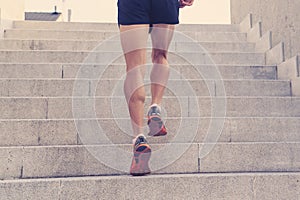 Close up of man running legs at sunset on a country road.