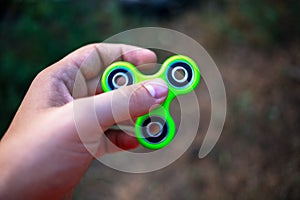 Close up of a man`s hand with fidget spinner