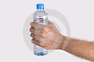 Close up man`s hand Holding Bottle of Water isolated on white b