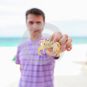 Close up of man's hand holding crab