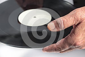 Close.up of man's hand while holds a vinyl record