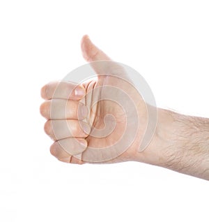 Close-up of a man`s hand with a raised thumb up on a white background, the concept of positive decision making, victory, approval