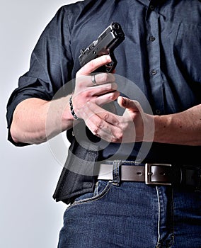 Close up of man& x27;s hand reloading pistol gun after shooting isolated