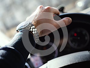 Close-Up Of Man's Hand On Steering Wheel