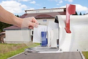 Close-up Of Man`s Hand Taking Letter From Mailbox