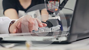 Close up of the man`s hand working on the computer.