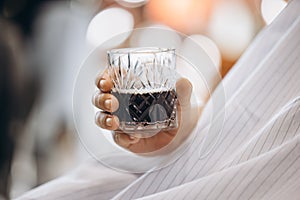 Close-up man's hands with glass. Beauty, healthcare and male cosmetics concept.